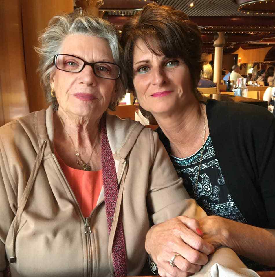 Two women sitting next to each other in a restaurant.